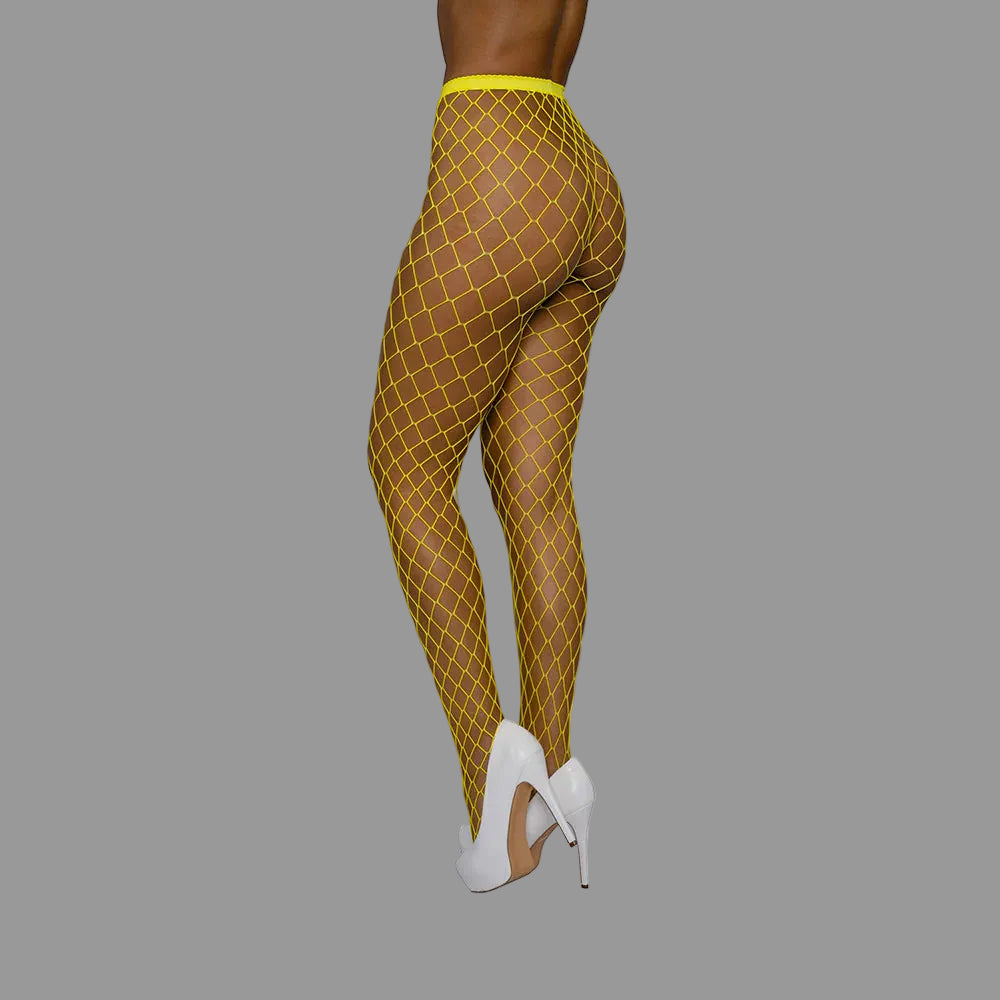 Yellow fishnet leggings worn by a person on a white background